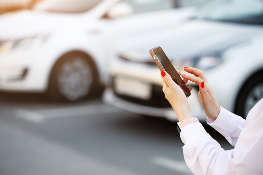 close-up-woman-hands-using-mobile-phone-communication-or-online-application-standing-near-car-on-city_t20_G0RezE