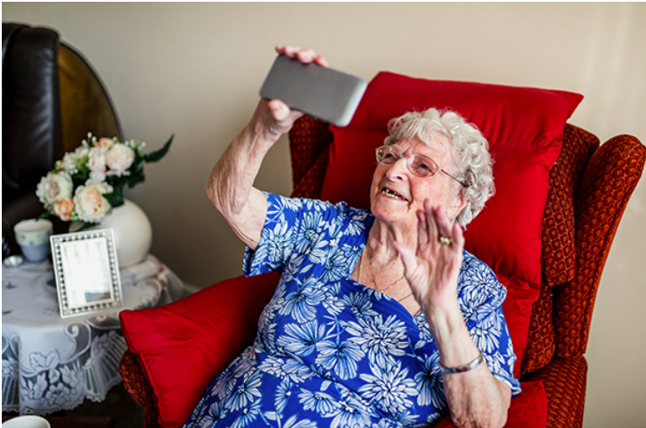 elderly woman holding smart phone